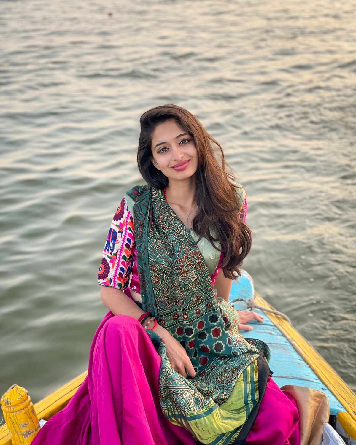Kamya smiling on a boat on the Ganga